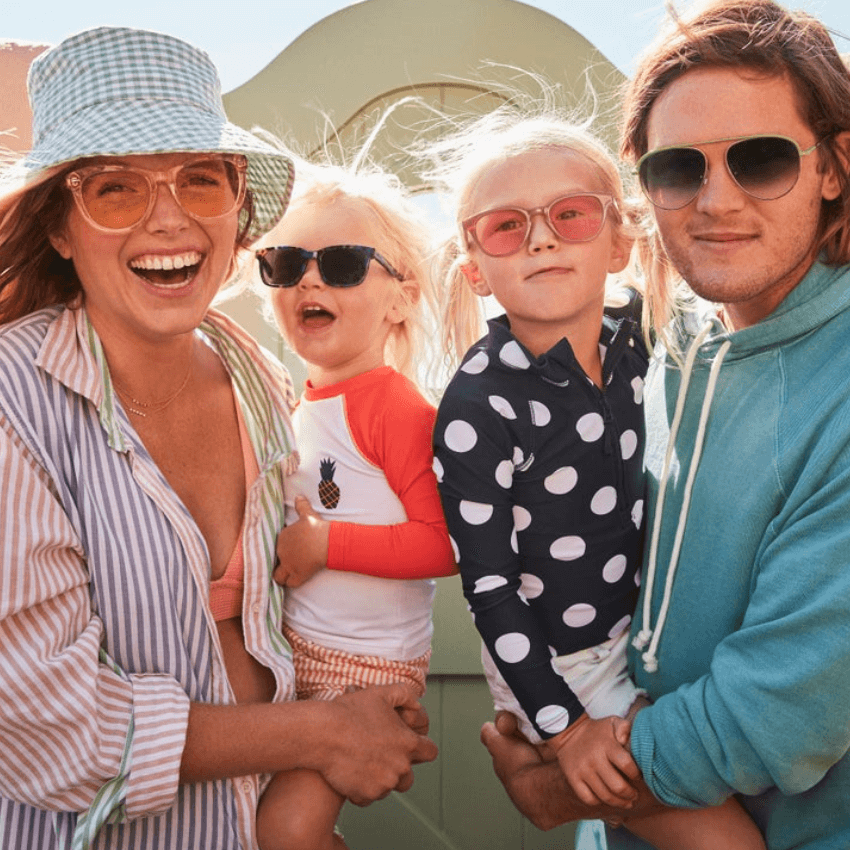 Family wearing polarized sunglasses with colorful, stylish frames, and UV-protective beachwear.