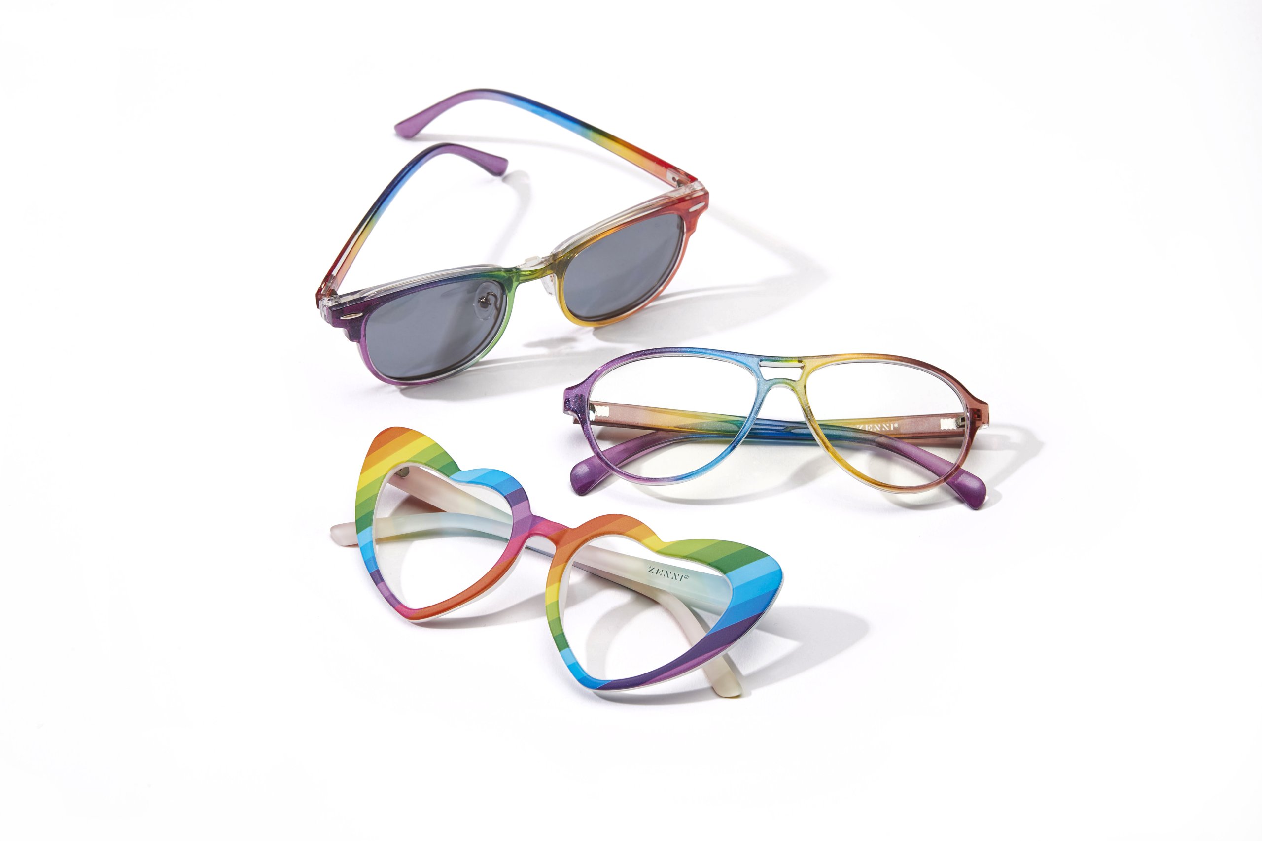 Three pairs of rainbow-colored eyeglasses, including heart-shaped frames.