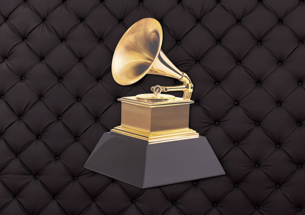 Gramophone trophy with a gold horn and base on a black, cushioned backdrop.
