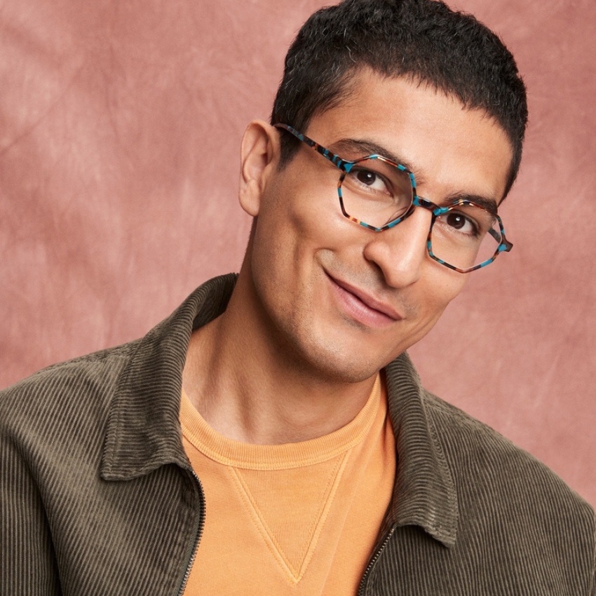 Man wearing geometric blue and tortoiseshell pattern glasses.